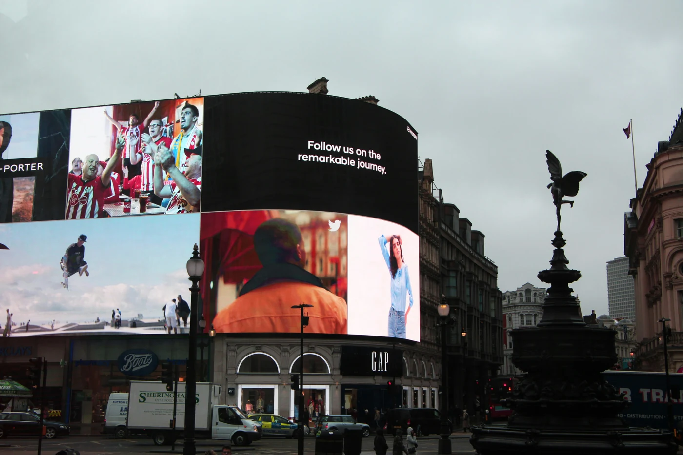 Woman displayed on a computer monitor in a rainy city scene