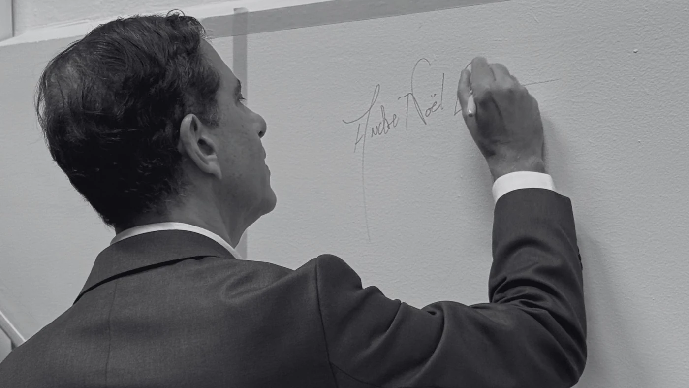 André Noël Chaker signing his name on the Persona Avatar wall during the creation of his official AI avatar André Noël Chaker signing his name on the Persona Avatar wall during the creation of his official AI avatar
